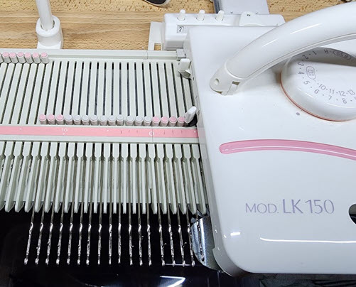 Carriage on Right Position in Machine Knitting Knitting machine carriage positioned on the right